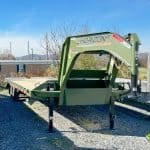 The Horizon GN-FHZSS30 deck over trailer with a green gooseneck and 30ft long wooden floor