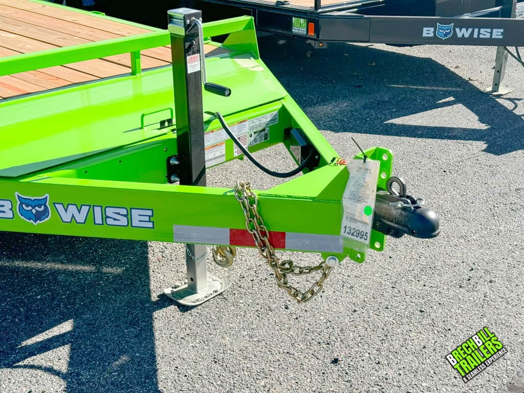 Black jack holding up the lime-green Bwise 12k equipment trailer at the Brechbill Trailers dealership