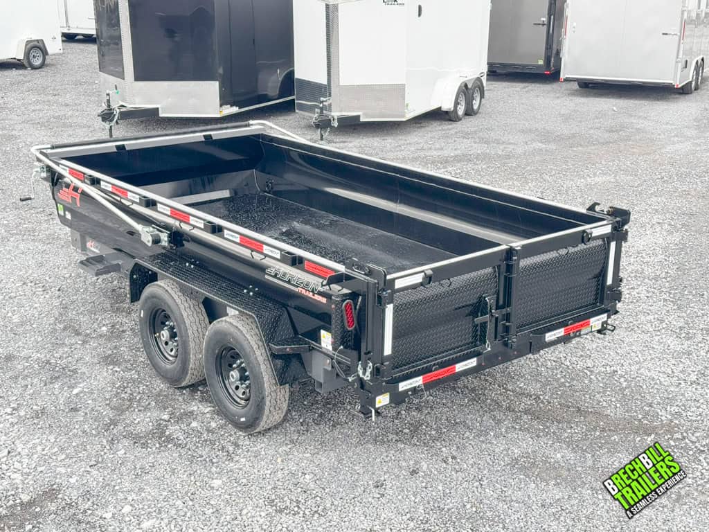 A black Horizon HD dump trailer parked at the Brechbill Trailers lot