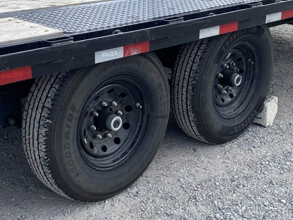 Black wheels and nice new tires on the used Big Tex gooseneck trailer