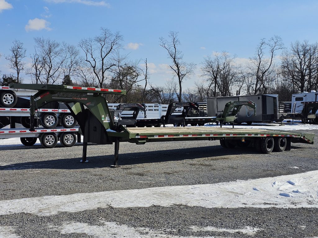 A green Used Horizon 40ft Flat Deck Gooseneck Trailer