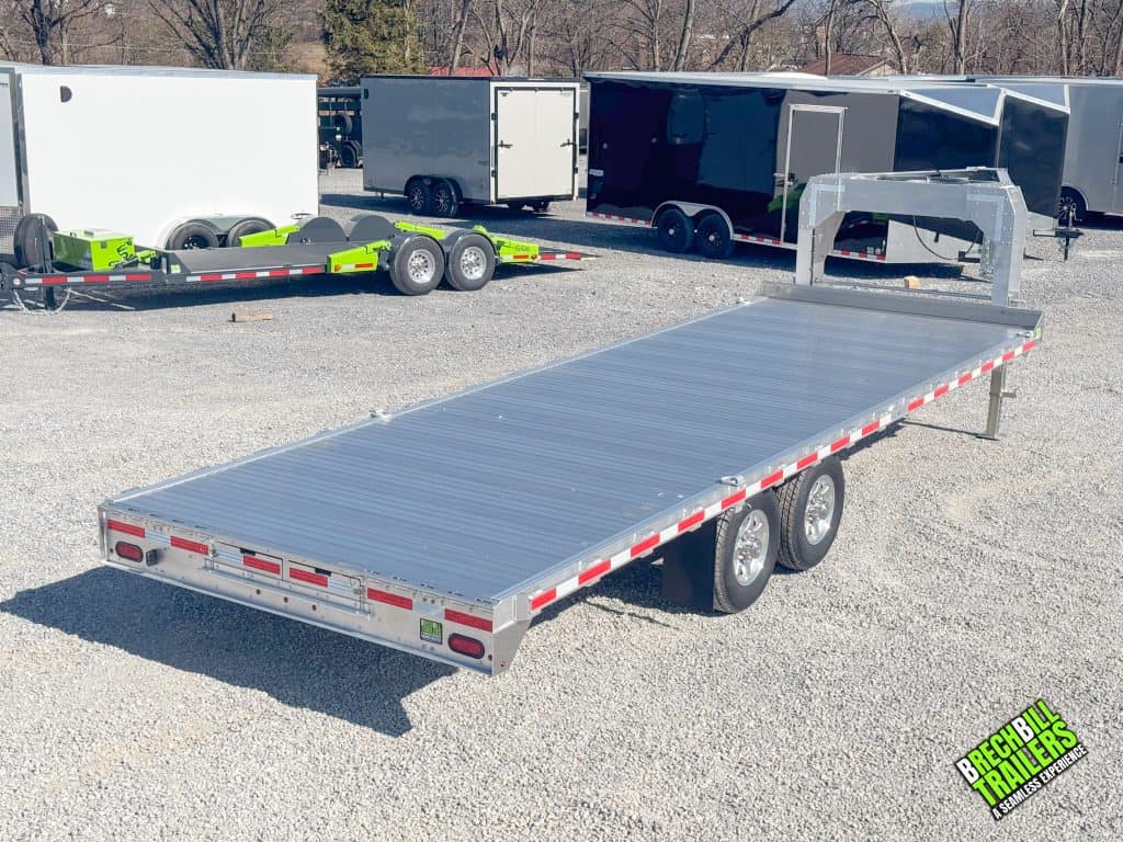 A parked EBY deck over gooseneck trailer for sale