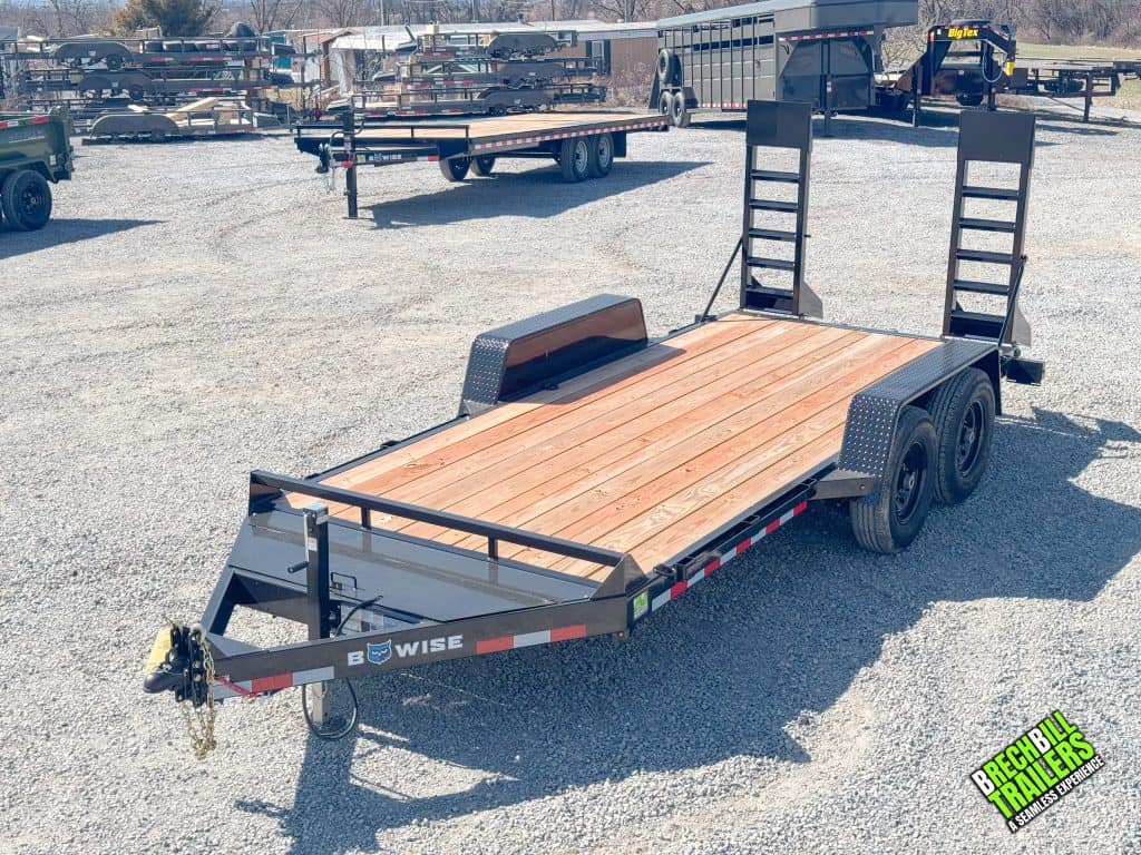 Black ladder ramps folded up on the parked Bwise low pro equipment trailer at Brechbill.