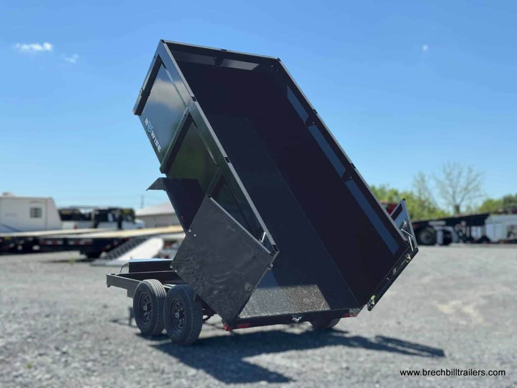 A black Bwise high side dump trailer on display at the Brechbill Trailers lot.