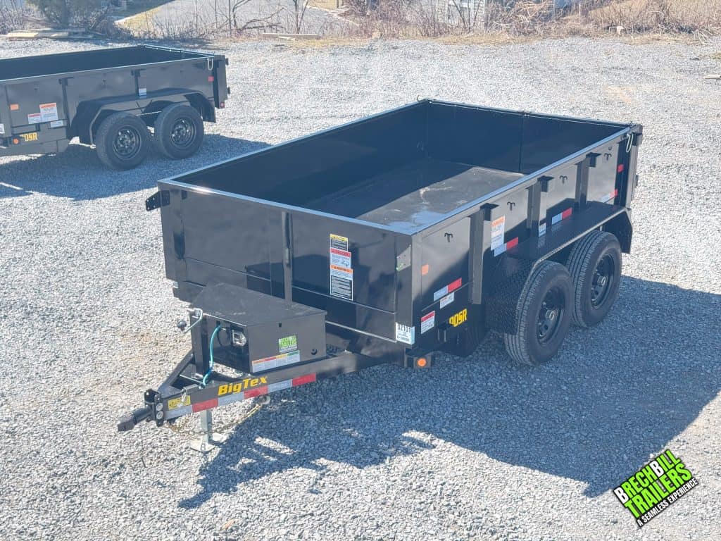 A parked Big Tex black dump trailer.