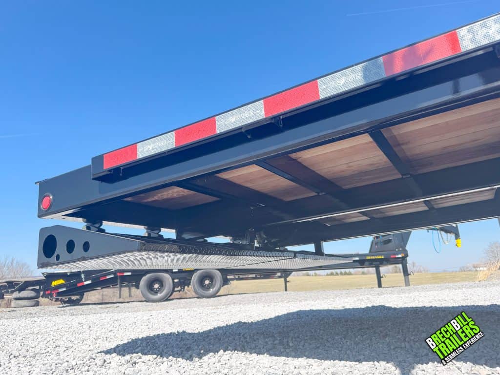 Ramps folded under the deck of the trailer